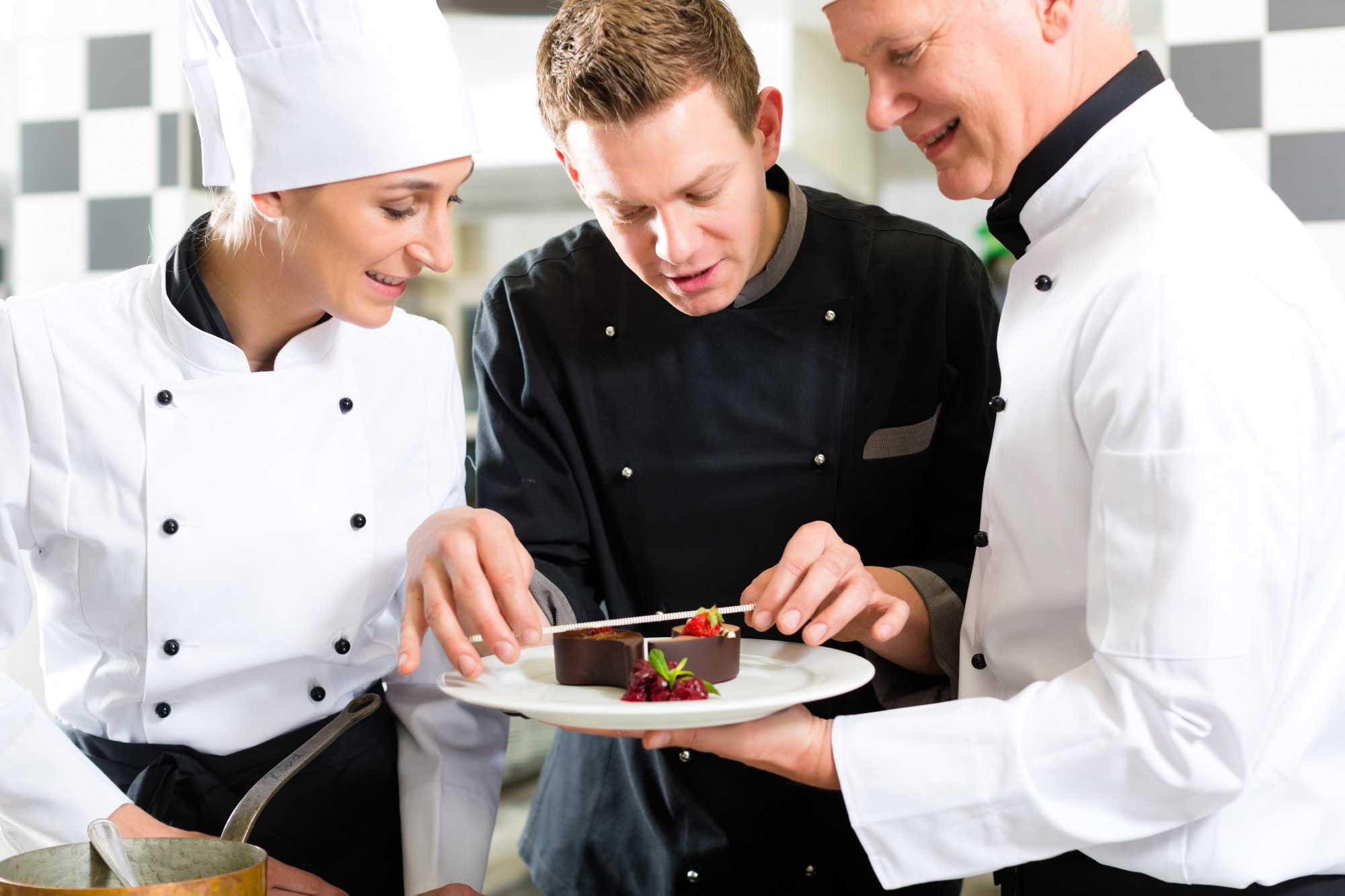 chef teaching plating to small team